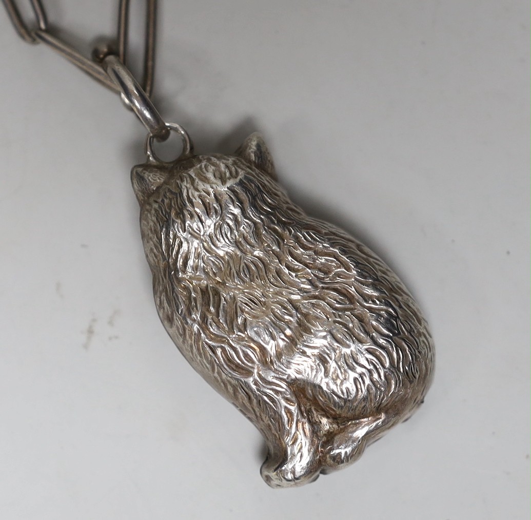 A modern silver rattle, modelled as a cat, 50mm, suspended from a 1920's silver albert.